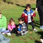 Students in the Child Development Center on the URI Campus play "Duck-duck-goose" during a recent "PE class" organized by education master's candidate Alyssa Alvez.