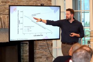 University of Rhode Island psychology Professor Justin Parent presents his study on positive parenting practices reducing adversity-related epigenetic aging in children during a College of Health Sciences research forum.