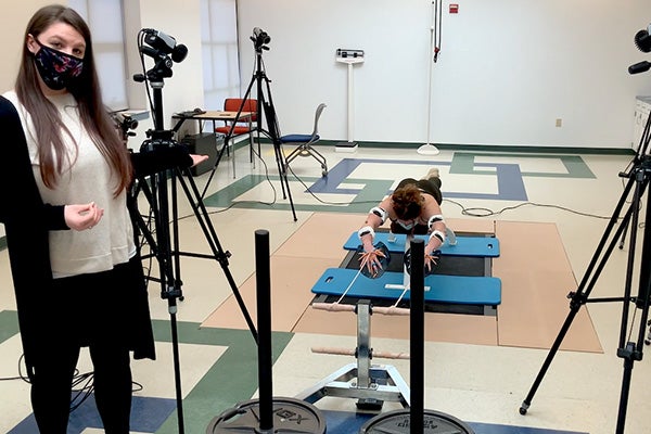 Kinesiology students Tabatha Hartshorn and Kendra Graham conduct a swim study in the URI Motion Capture Lab, one of the facilities high school students will use during Biomechanics Day April 6.