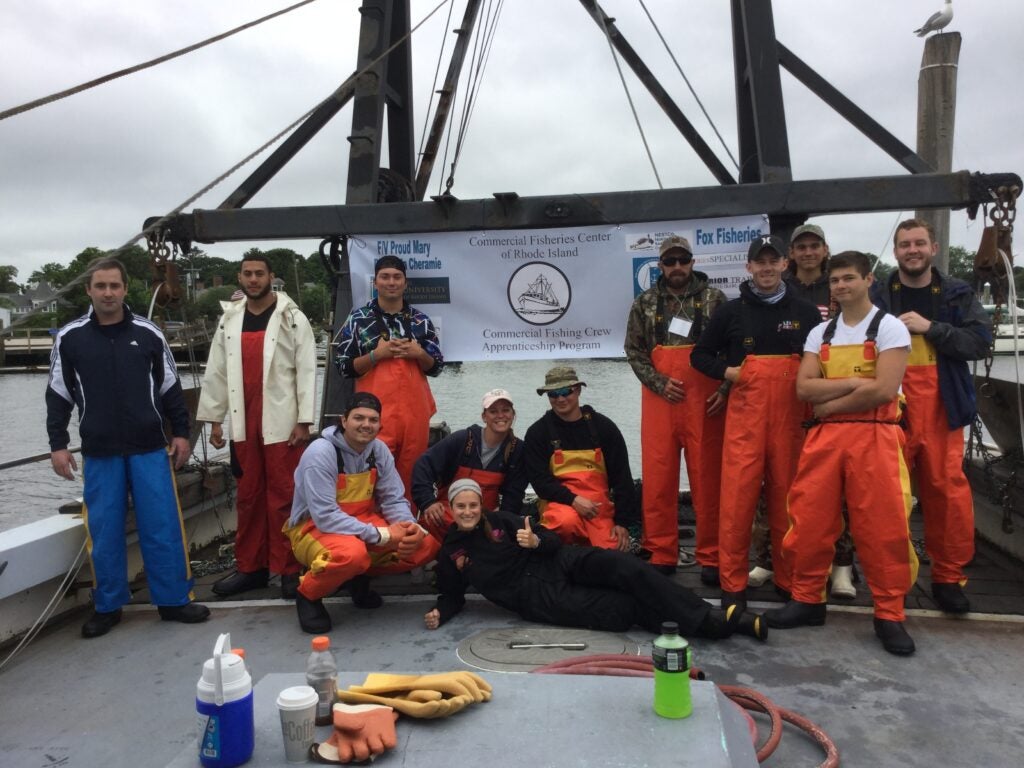 group photo of fishers on commercial fishing boat