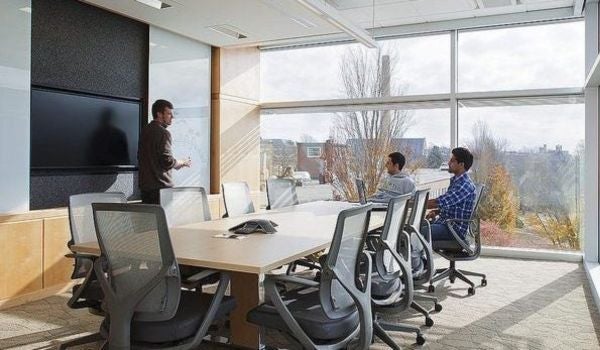 two people sit in a conference room