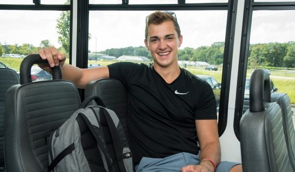 a student riding the rhody shuttle