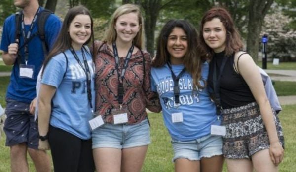 4 students gathered smiling