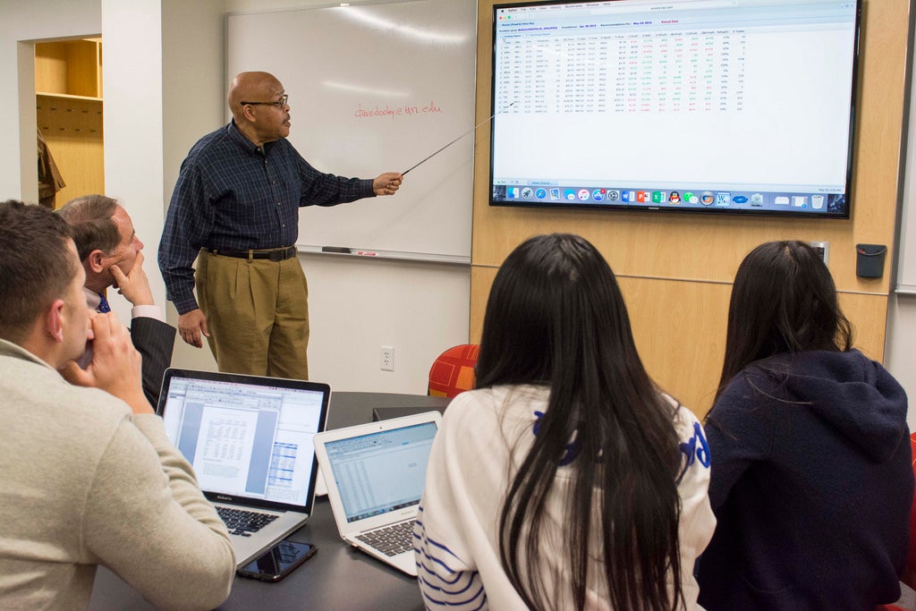 Teacher teaching in front of a classroom full of students