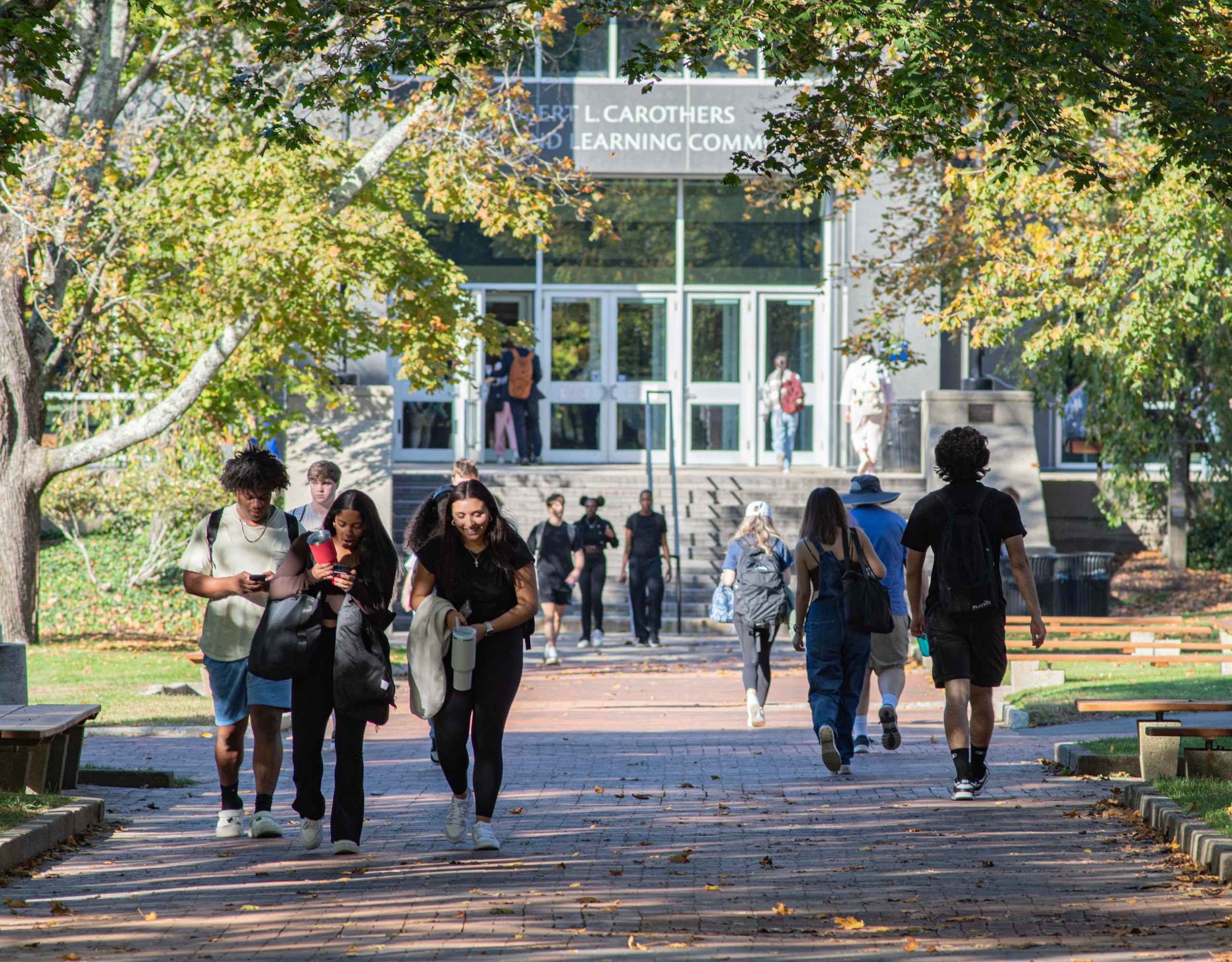 students walking on campus on a sunny day