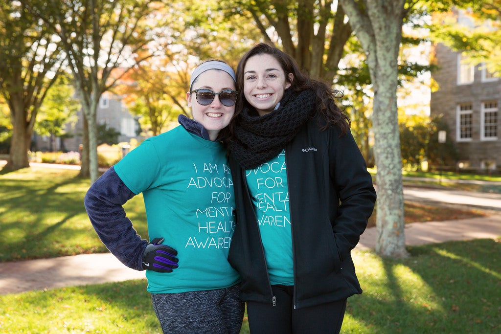 Two girls wearing teal colored shirts saying, 