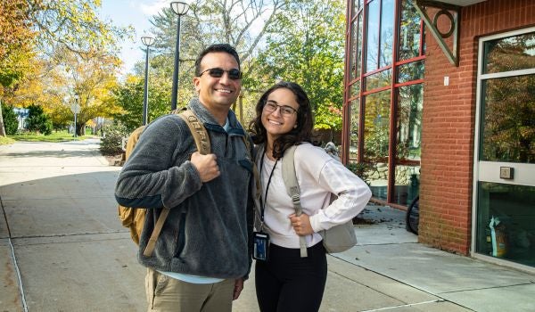 two Veterans smiling on campus