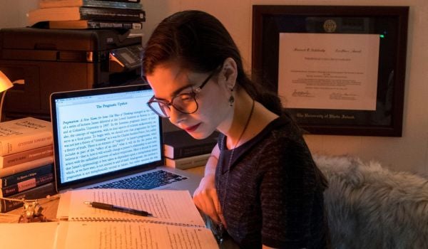 a student studying in her on campus housing