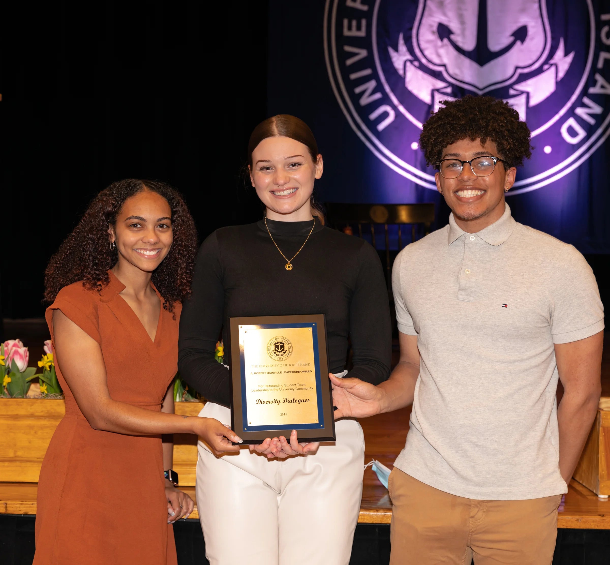 Three Diversity Dialogue members pose for a photo holding up their award at the Inclusive Excellence Ceremony