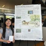 Ellie Lin stands with her poster at the SURF showcase.