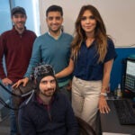 Ph.D. students John McLinden and Behtom Adeli stand with associate professor Yalda Shahriari and master’s degree student Alex Cerullo, seated, in the NeuralPC Lab