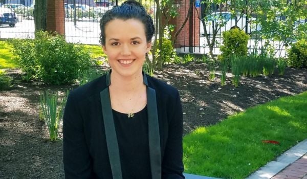 a student smiling on campus