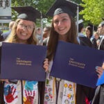 Corcoran and Flynn celebrate their URI graduation together in May 2025.