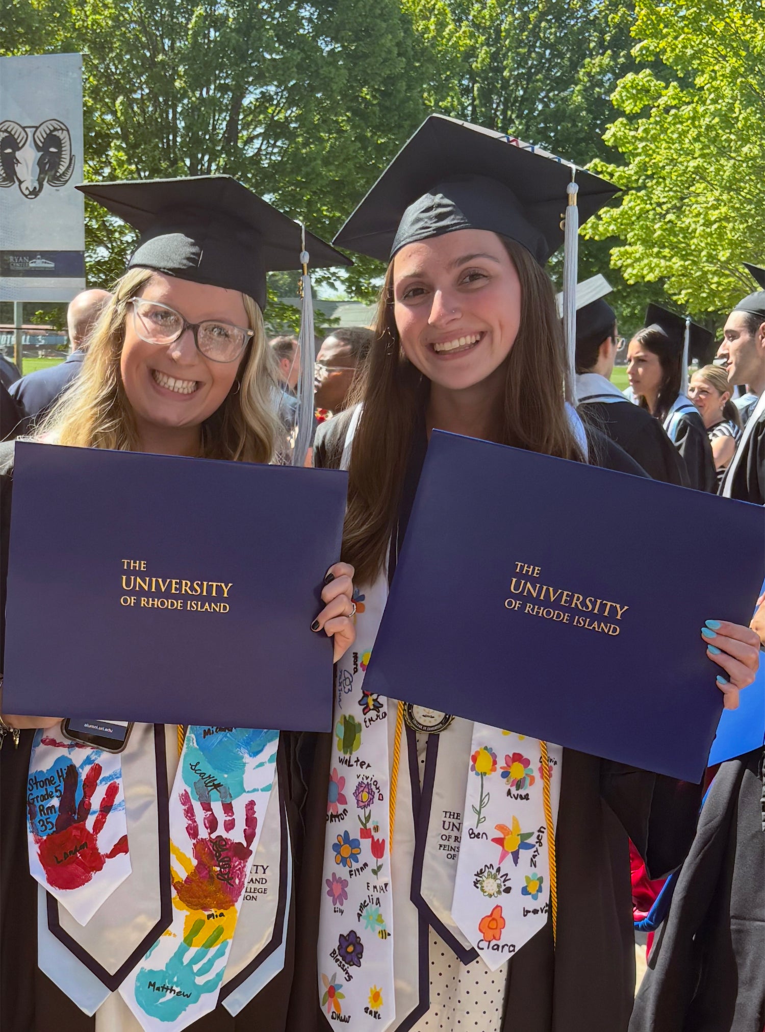 Corcoran and Flynn celebrate their URI graduation together in May 2025.