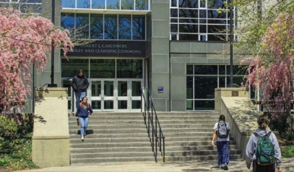 students walking in and out of the library