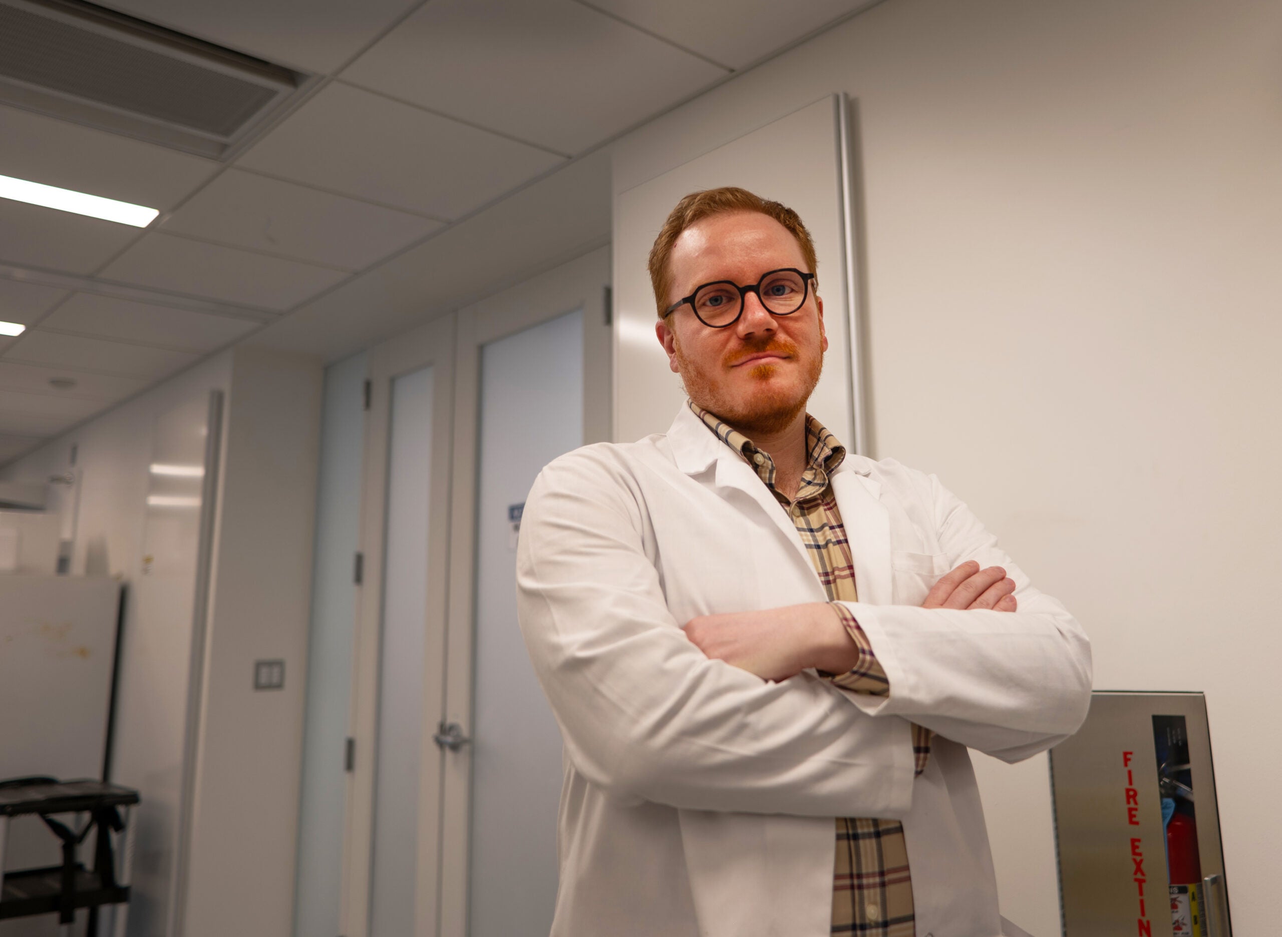 Dr. Poling-Skutvik poses arms crossed in his white lab coat