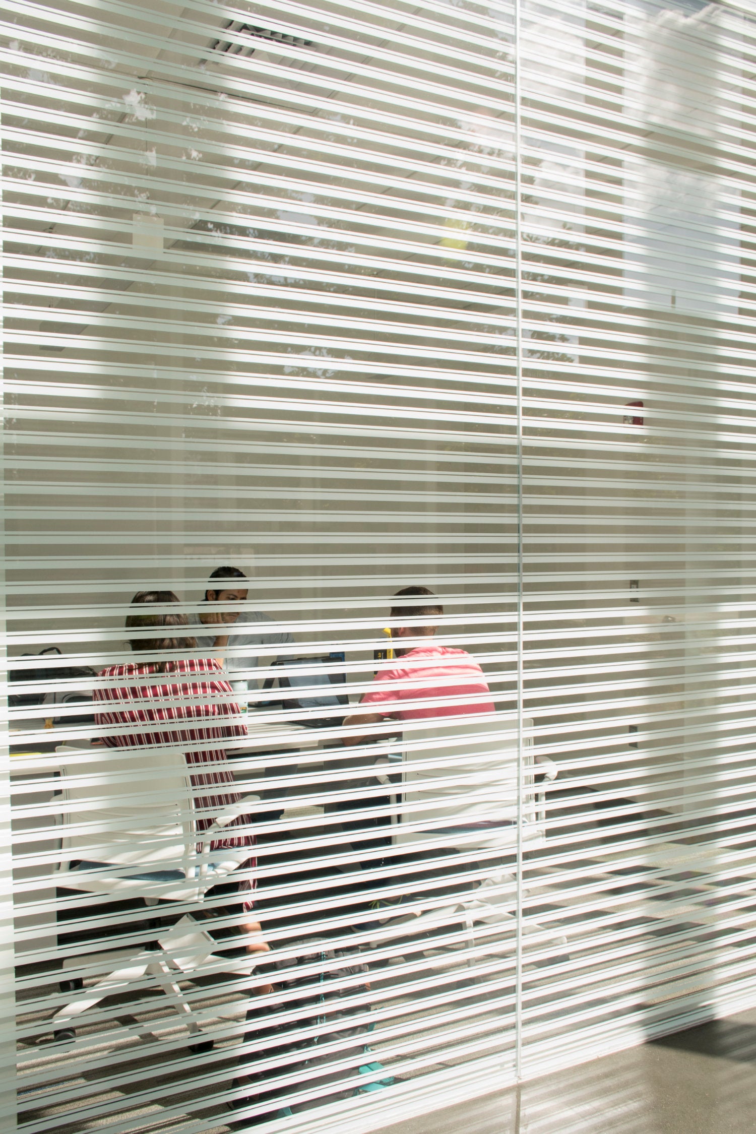 A view inside a classroom through closed blinds
