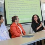 Faculty sit at a table to discuss the new textiles council