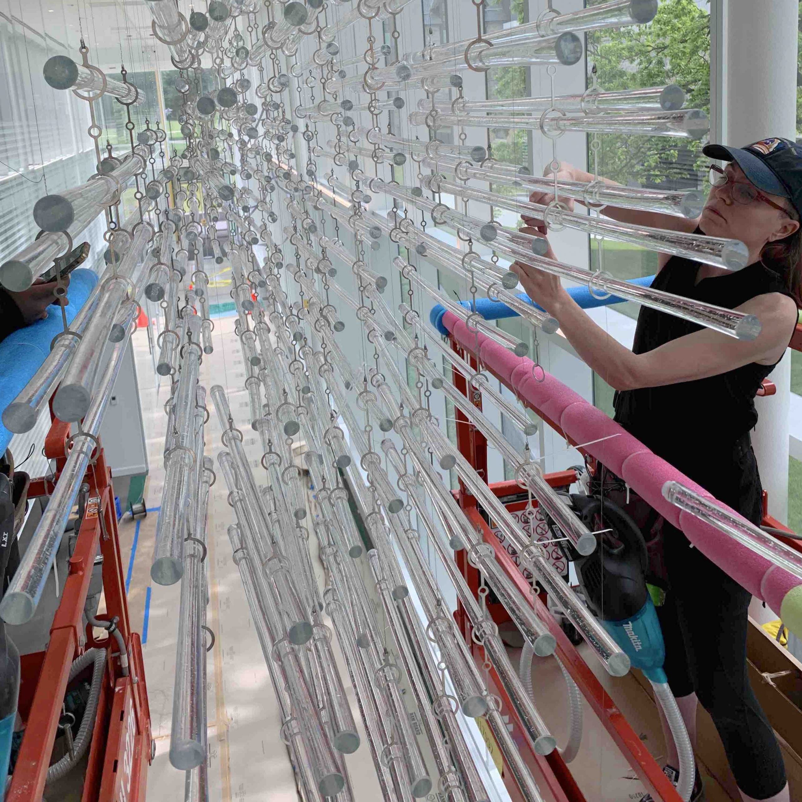 Jenn Figg installing glass artwork