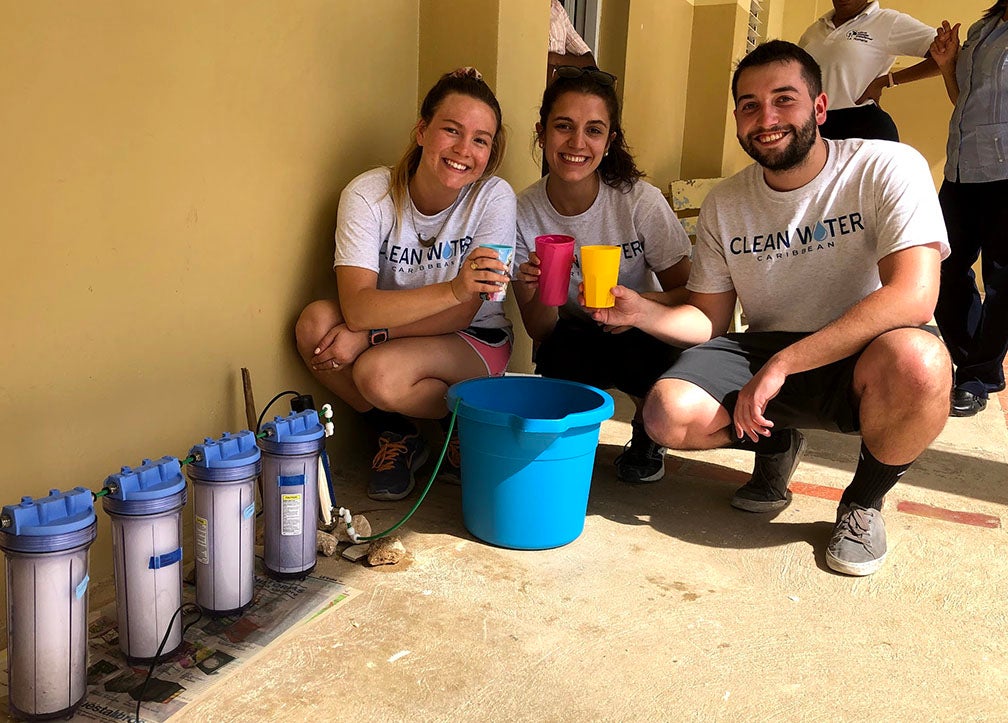 From left, Isabella Silverman, Alexa Leone and Ian Hallam experience the results of their water treatment system. Photo courtesy of Isabella Silverman