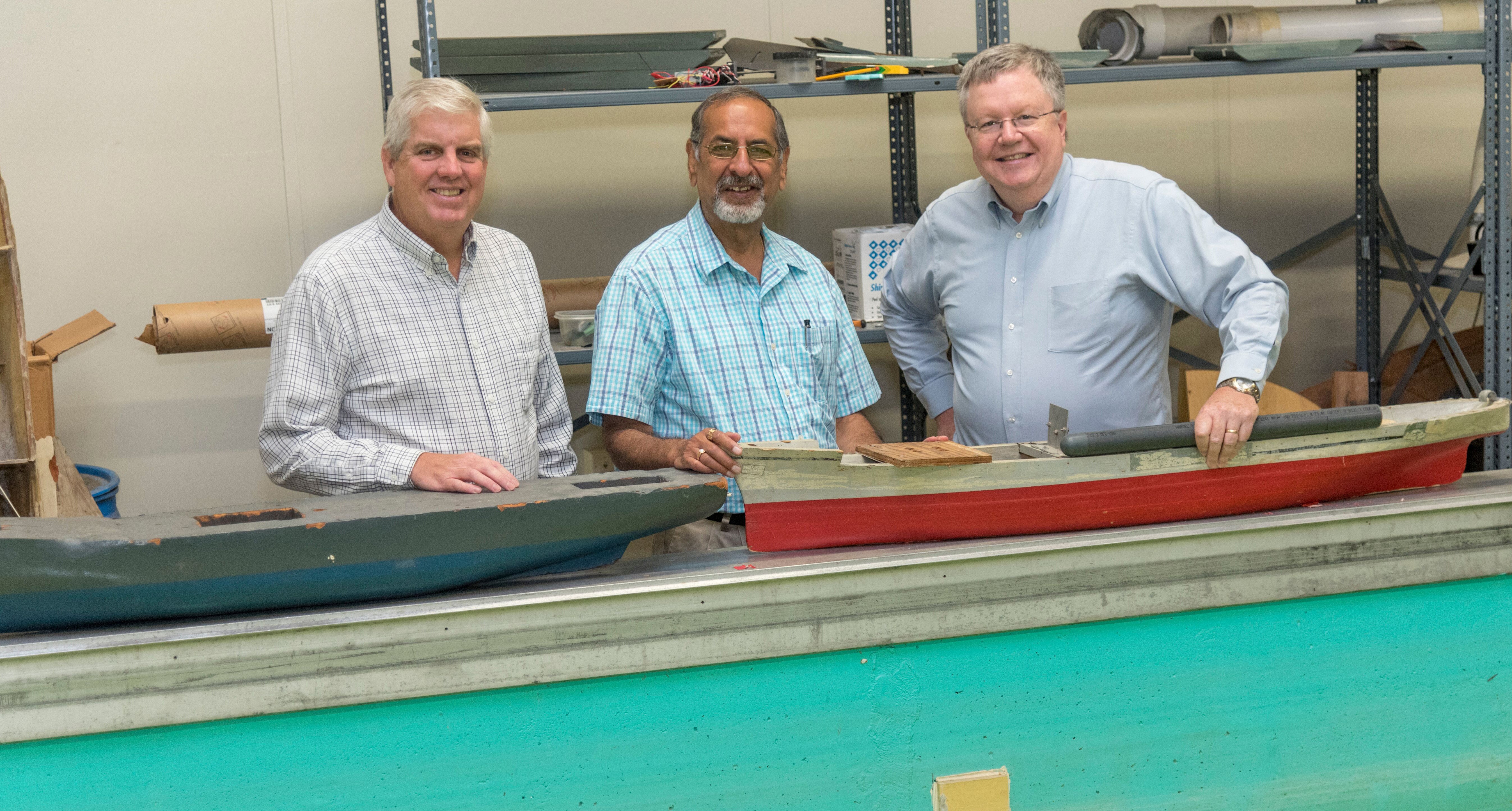 URI engineering professors David Taggart, Arun Shukla and James Miller in Miller’s laboratory.