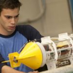 A student works on a submersible drone