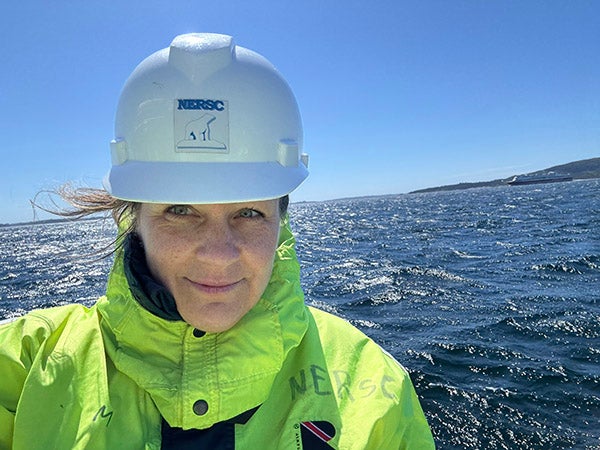 Lora Van Uffelen at sea with a hard hat on