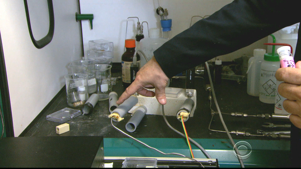 Professor Gregory demonstrates how the TATP detection device works while holding a small sample