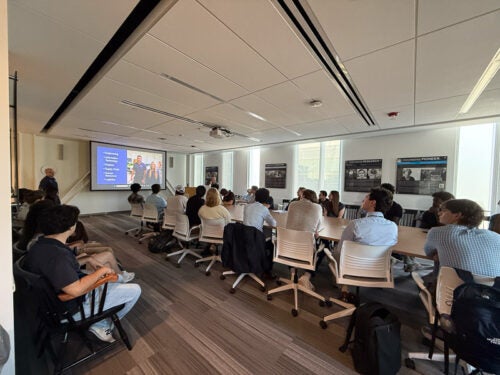 Students listen to a presentation about the BMW PACE program in a conference room