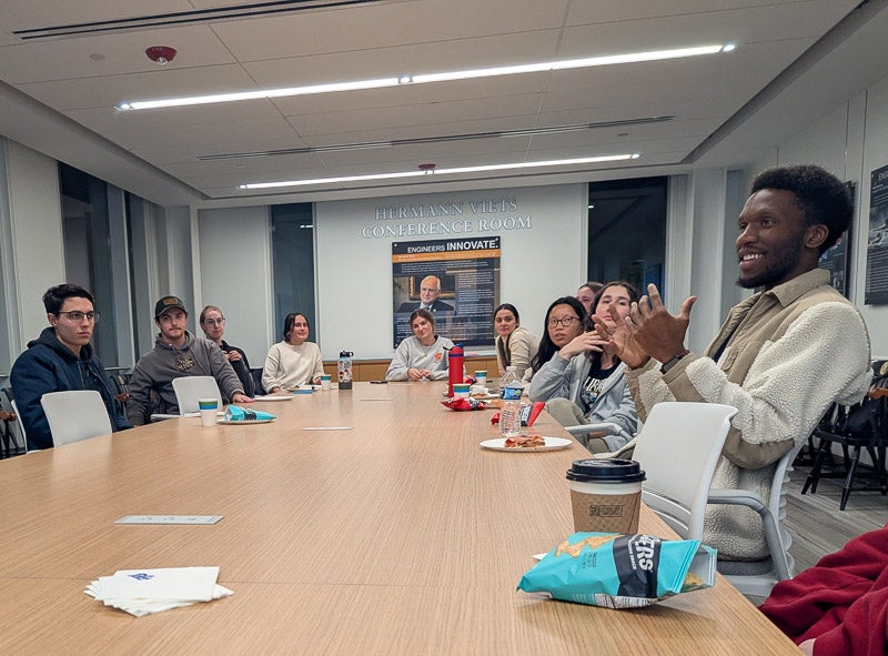 Students discuss in a large group how skills learned abroad can help them in their careers