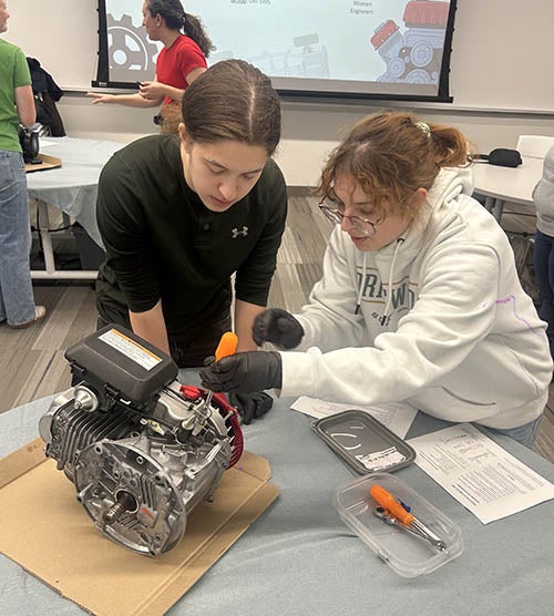 Eleni and another student working on a motor