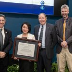 ENRE faculty member Emi Uchida, receiving her Research Excellence Award