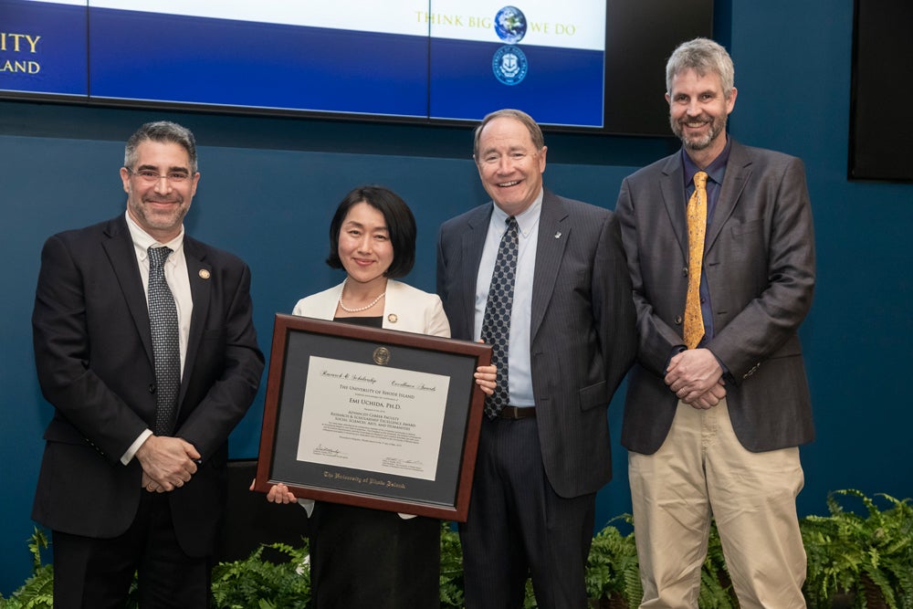 ENRE faculty member Emi Uchida, receiving her Research Excellence Award