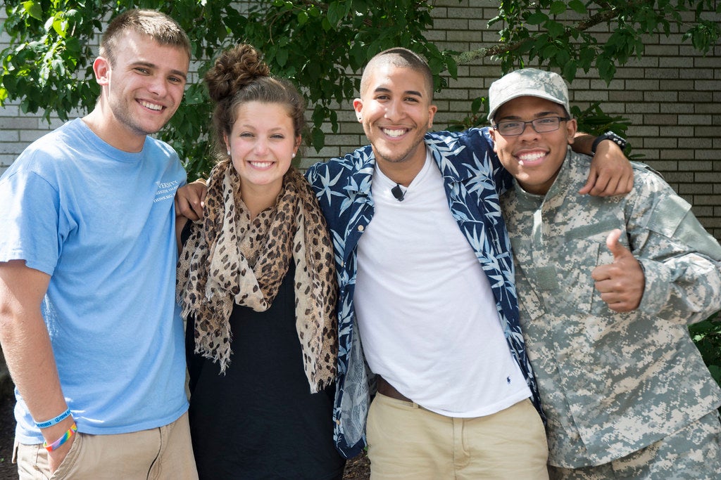 URI Is a community that works together. Image is of four people posing for a picture.