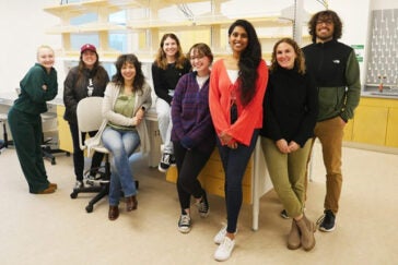 Dr. Fallini (seated) with students in her lab,
Spring 2023