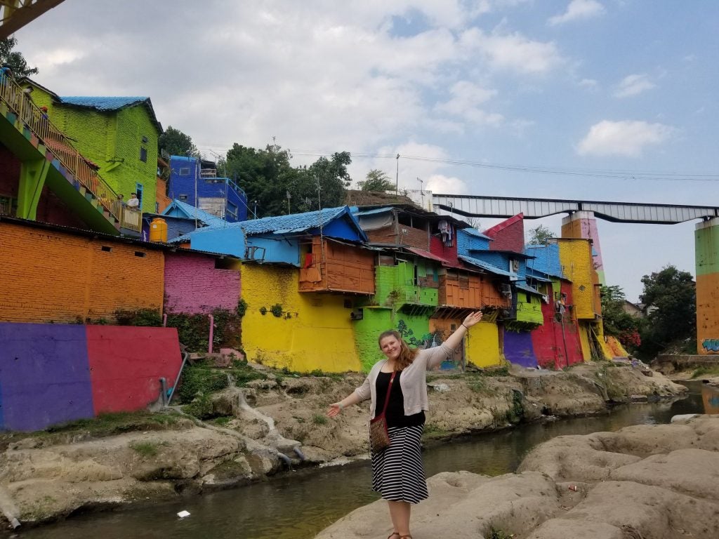 Tabatha Lewis in front of a colorful wall in Indonesia