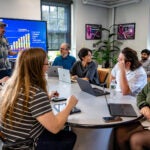 A group of U²GRC students and faculty having an energetic discussion in URI's "AstroSpace" common area.