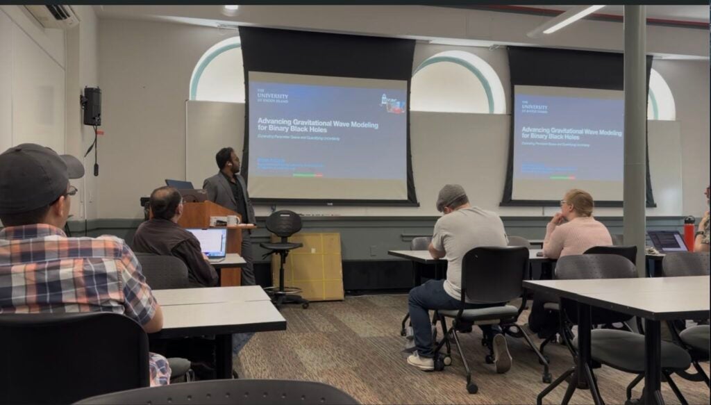 Ritesh Bachhar presenting his dissertation defense on gravitational waveform modeling for binary black holes.