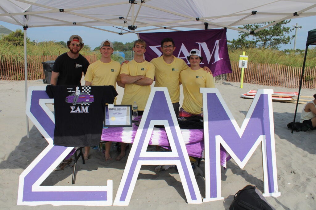 fraternity brothers at a recruitment table