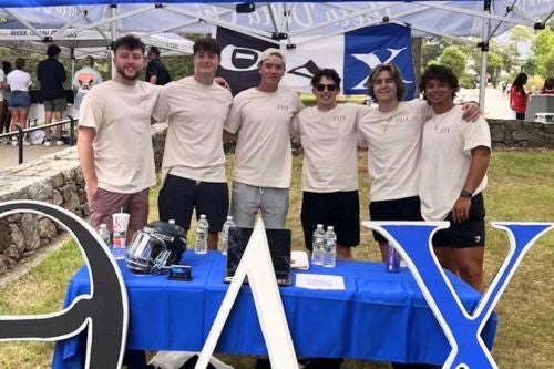 fraternity brothers at an activity fair