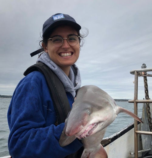 Nina Santos holding a small shark