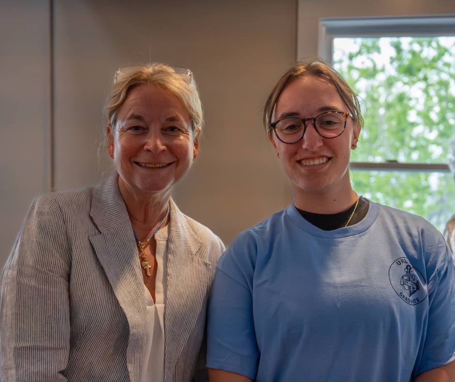 A student and faculty advisor smile in Mosby.
