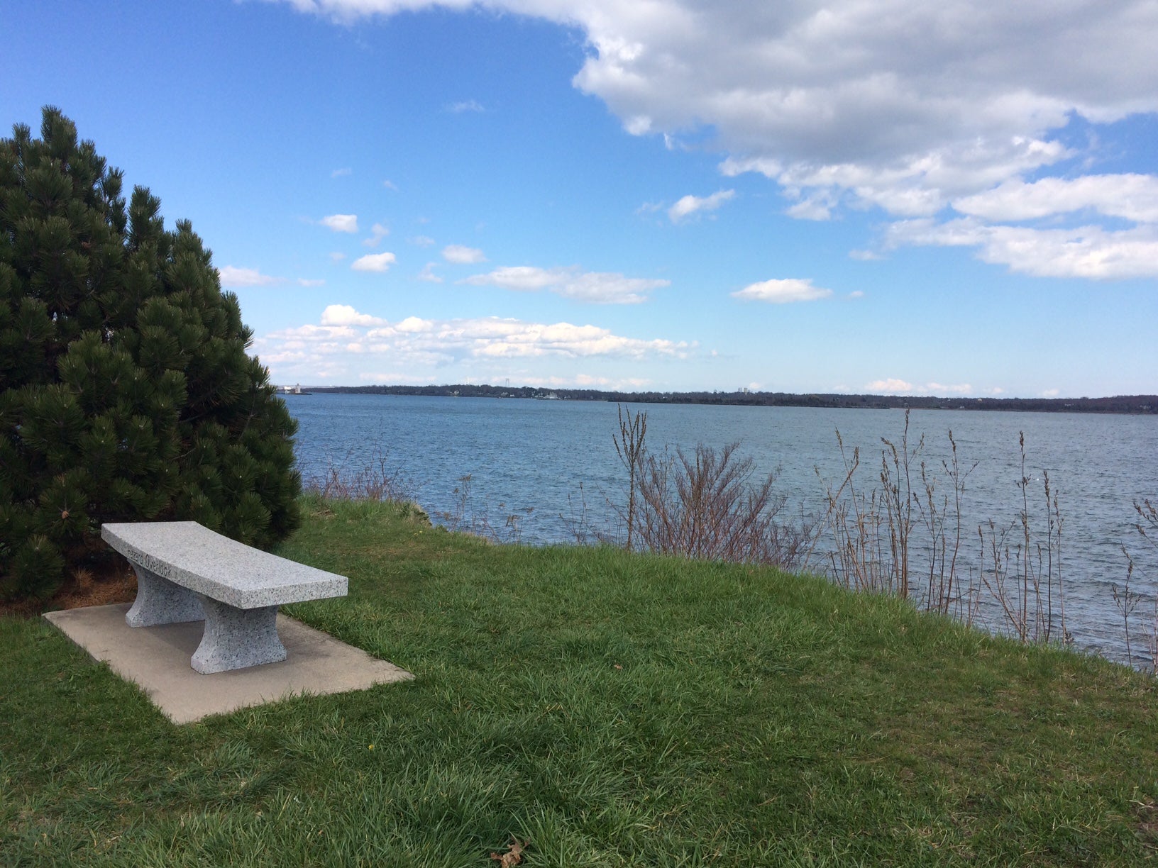 Narragansett Bay overlook with a bench in the foreground.