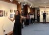 Alyssa Tsukada speaking to a crowd in the Studio Blue Gallery during an opening reception.