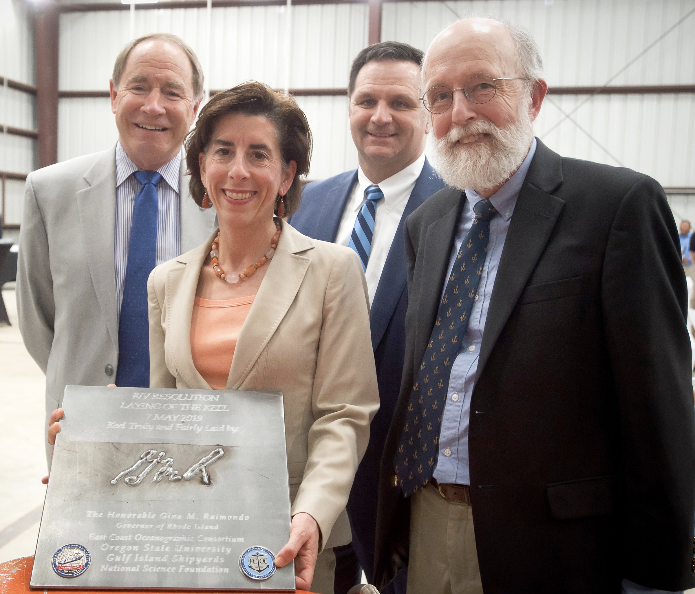 Four VIPs with Resolution's Keel-Laying plaque