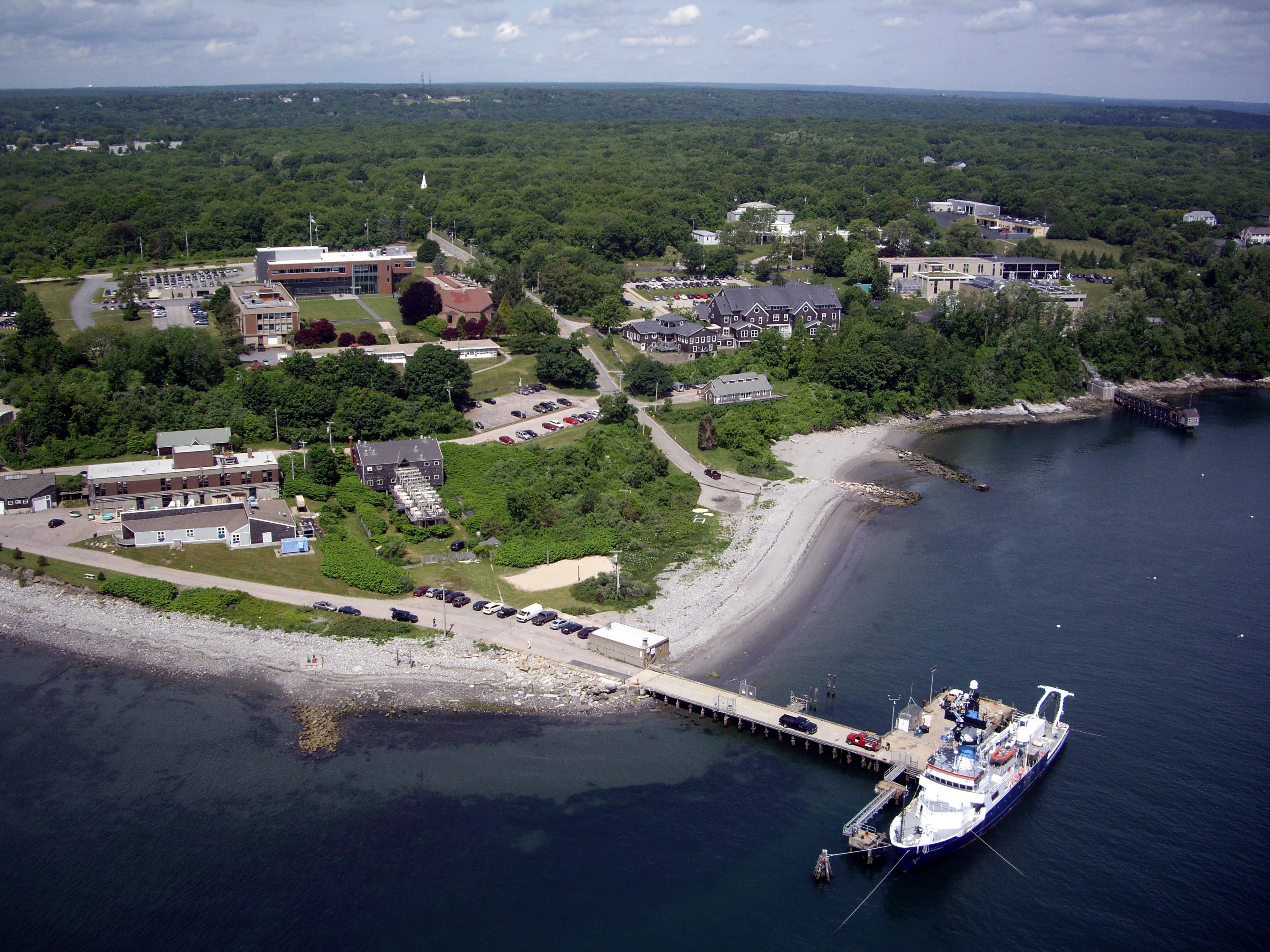 Aerial view of the Bay Campus and backyard with dock and ship. Photograph by Don Bousquet.