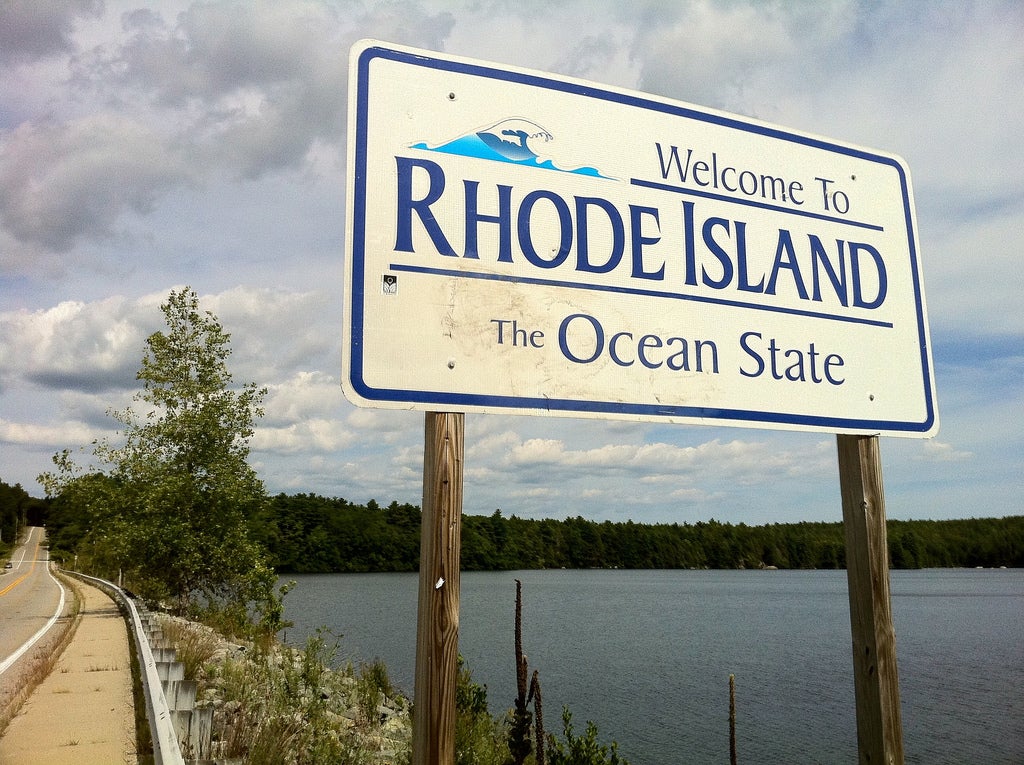 A roadside sign that says "Welcome to Rhode Island, the Ocean State."