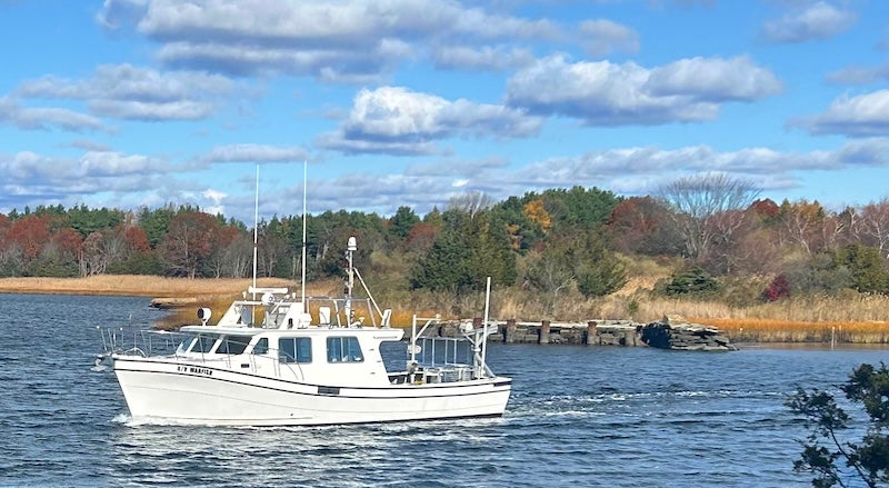 A 45-foot motorboat cruising through coastal waters.