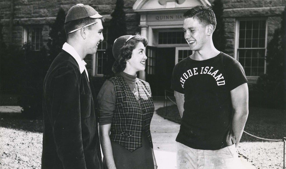 historic black and white image of students in front of quin hall on the quad 