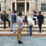 a group of film/media students shooting a scene for a project outside of Green Hall on the Kingston Campus.